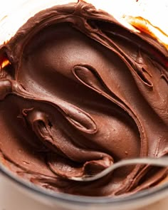 chocolate frosting in a blender with a spoon