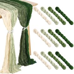 several pieces of green and white yarn tied to a wooden structure with ropes on each side