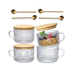 four glass mugs with spoons and gold handles