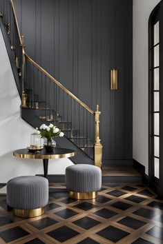 a black and gold room with two stools next to a table on the floor