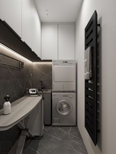 a washer and dryer in a small laundry room with marble counter tops on either side