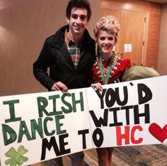 two people holding signs that say i irish you'd dance with me to hhc