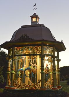 an ornate gazebo lit up at night