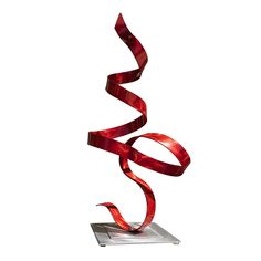 a metal sculpture with red ribbons on it