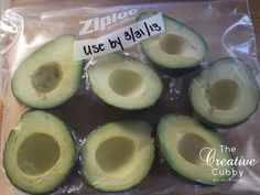 an avocado cut in half on a plastic bag