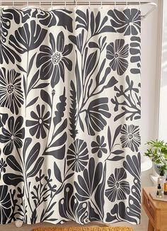 a black and white shower curtain with flowers on it