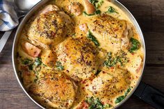 a pan filled with chicken and spinach covered in cheese