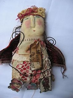 an old cloth doll with a crown on it's head