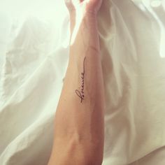 a woman's arm with the word hope written in cursive writing