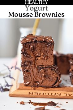 there is a piece of chocolate cake on the table with text overlay that reads healthy yogurt mouse brownies