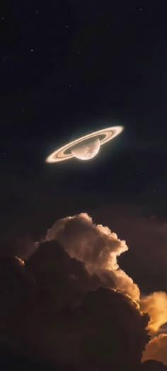 an object is flying in the sky above some clouds and dark night skies with stars