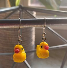 yellow rubber ducky earrings hanging from hooks