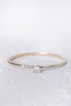 a yellow gold ring with two diamonds on it