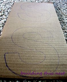 a cardboard box with the letter s drawn on it