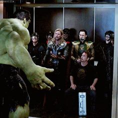 the avengers movie is being filmed in an elevator with many people dressed as superheros