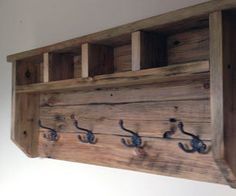 a wooden shelf with hooks on it