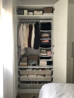 an organized closet with clothes and other items