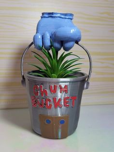 there is a plant in a bucket that says g u m bucketet on it