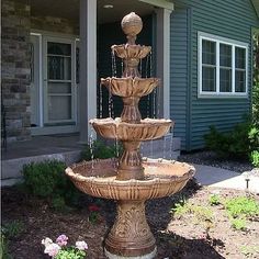 a water fountain in front of a house