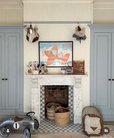 a living room filled with furniture and a fire place in front of a painting on the wall