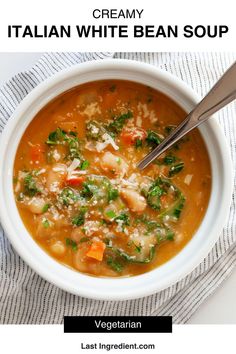 a white bowl filled with soup next to a spoon