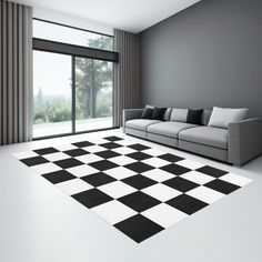 a black and white checkered area rug in a living room with a couch, windows, and sliding glass doors