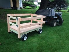 a lawn mower sitting next to a wooden cart