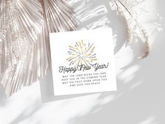 a card with the words happy new year written on it next to some dried plants