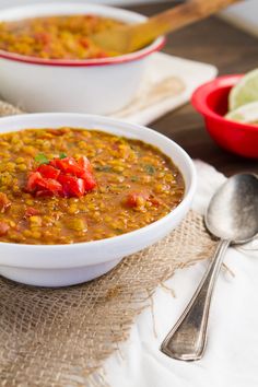 a white bowl filled with beans and tomatoes