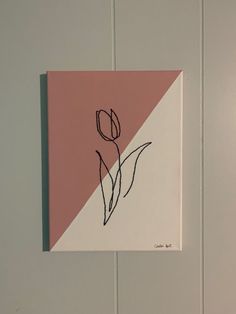 a pink and white square with a flower drawn on it