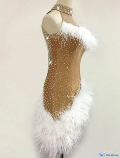 a mannequin dressed in gold and white feathers