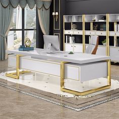 an office desk with gold accents and white furniture