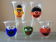 six plastic cups with sesame characters painted on them