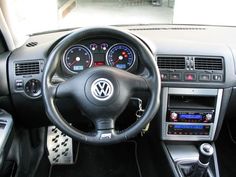 the interior of a car with dashboard controls and gauges