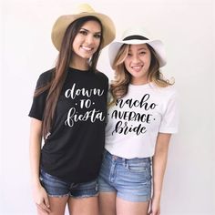 two young women standing next to each other wearing t - shirts that say down la fiesta