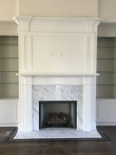 a fireplace with white marble surround and mantle