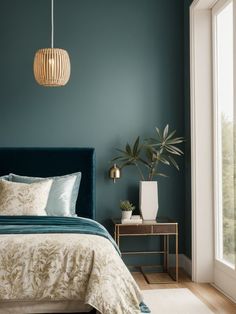 a bedroom with green walls and blue bedding in the corner, along with a plant