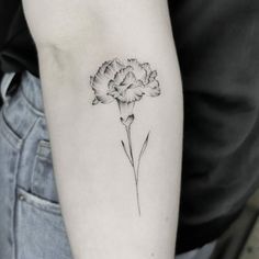 a black and white photo of a flower on the arm