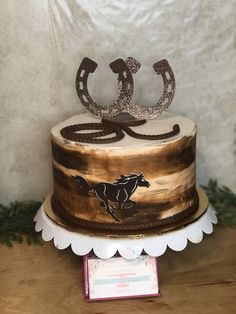 a horse themed cake on a wooden table