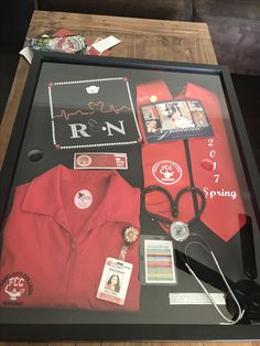 a display case with an assortment of items on it, including a doctor's coat and stethoscope