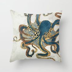 an octopus pillow is shown on a white wall with a blue and brown octopus design