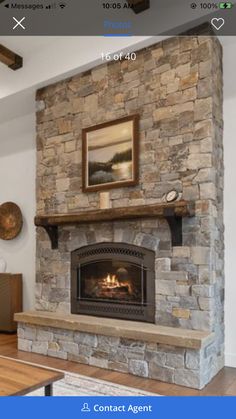 a stone fireplace is shown in the living room