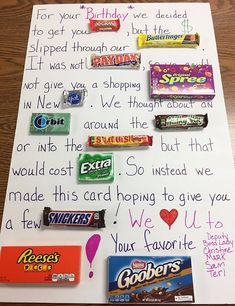 a handwritten birthday card with candy bars and candies on it's side