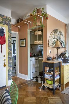 a kitchen with yellow cabinets and wooden floors