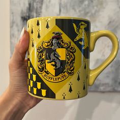 a person holding a harry potter mug in their hand