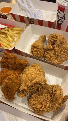 two boxes filled with fried chicken and french fries