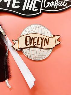 a wooden sign with the name evelyn on it next to a pair of white scissors