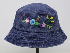 a blue hat with colorful flowers on it