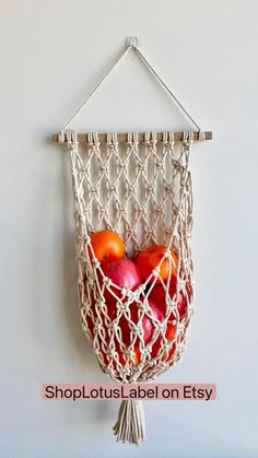 apples in a macrame bag hanging on a wall