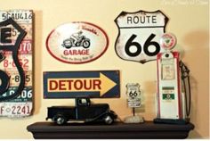 various signs on the wall with a car and gas pump in between one sign that says route 66